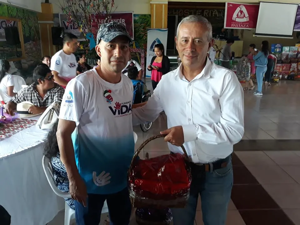 EL CORONEL LUIS ESTRELLA ENTREGANDO UNA CANASTA A UN ENFERMO DE CÁNCER